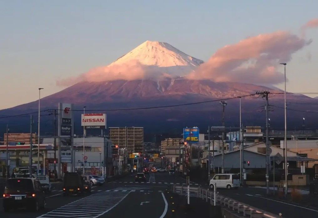 Street view leading toward majestic Mount Fuji in Fujiyoshida in evening