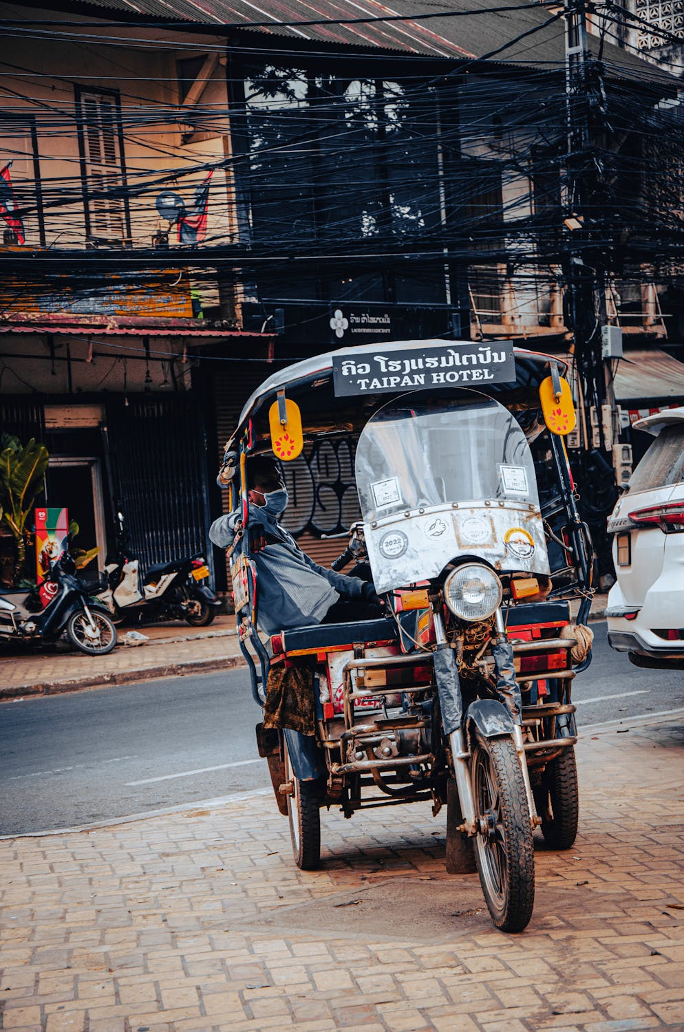 Another tuk tuk parked somewhere on the side of the road