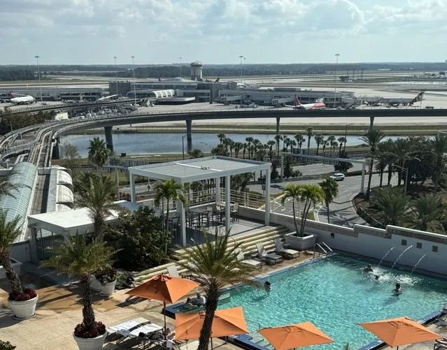 Hotel pool overlooking Orlando International Airport and its runways