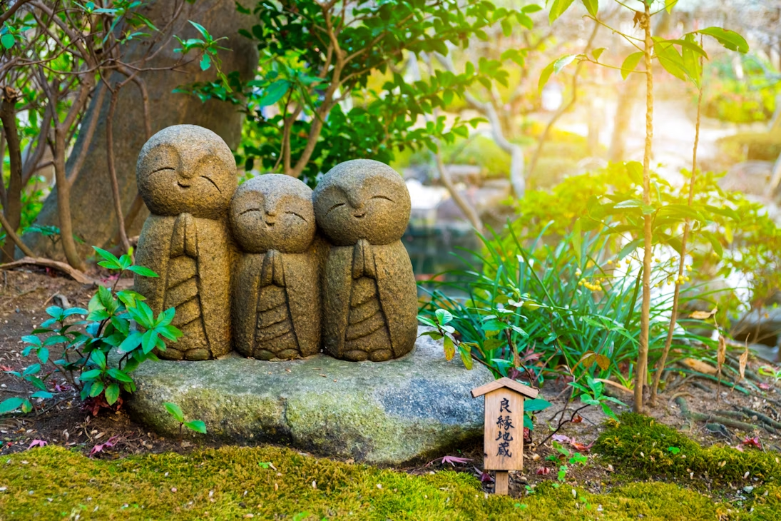Cute carvings of little rock monks on a pedestle