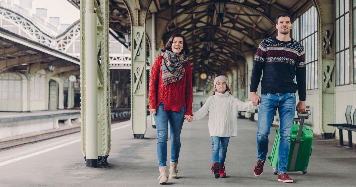 1. Family with luggage walking through a railway station