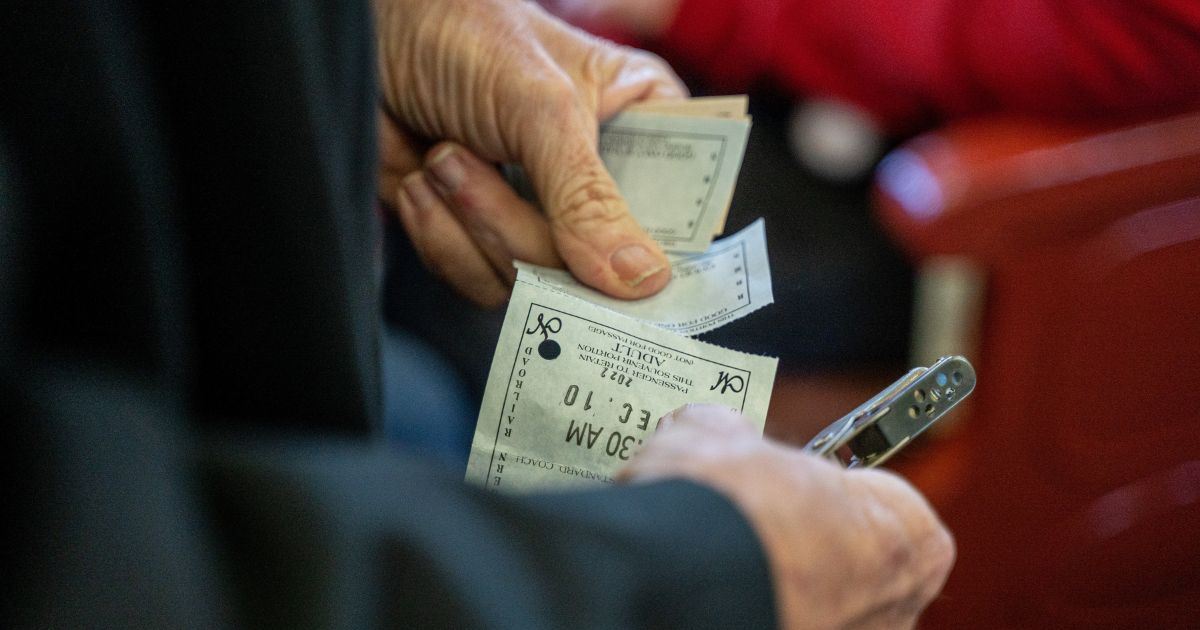 A passenger showing a train ticket