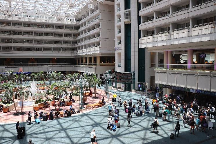Travelers walking through a busy terminal at Orlando Airport