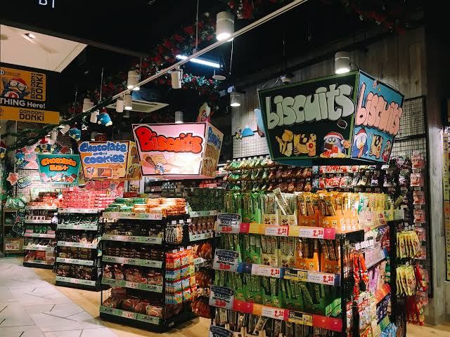 Japanese biscuits and snacks filling a Donki store aisle