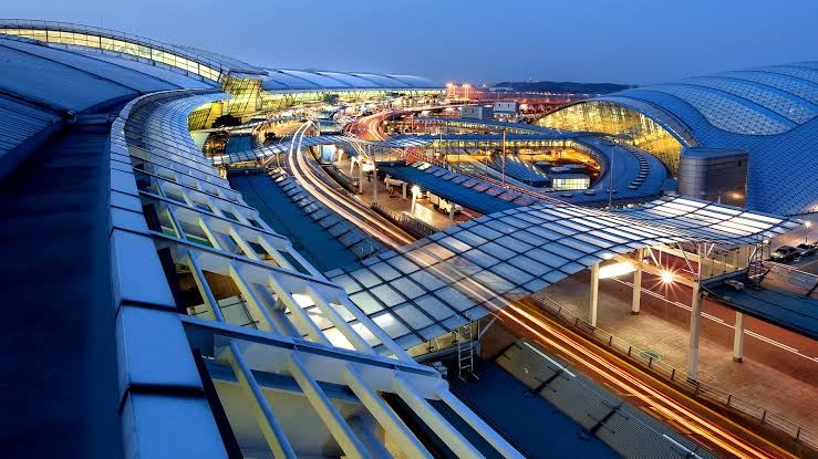 Incheon International Airport’s illuminated terminal complex at dusk.