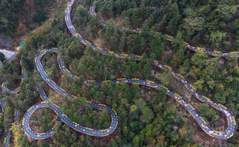 Winding mountain road through a forested landscape