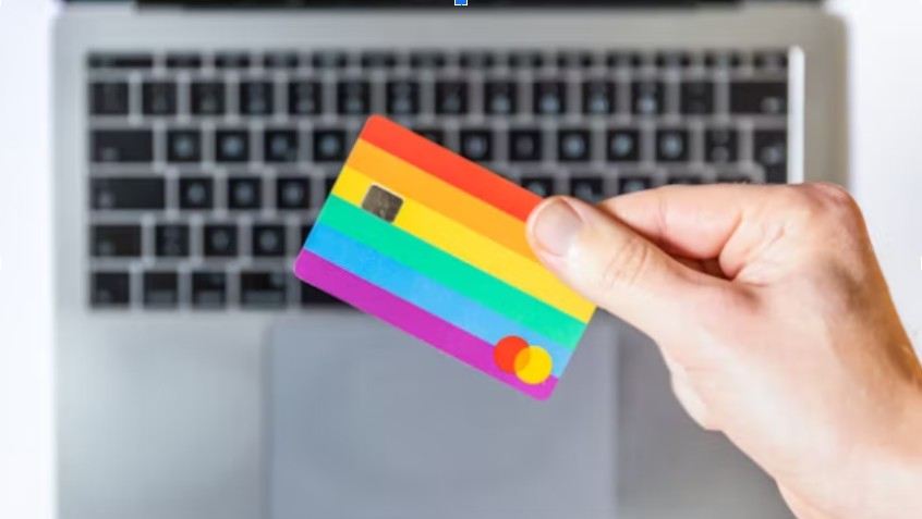 A colorful credit card in front of keyboard