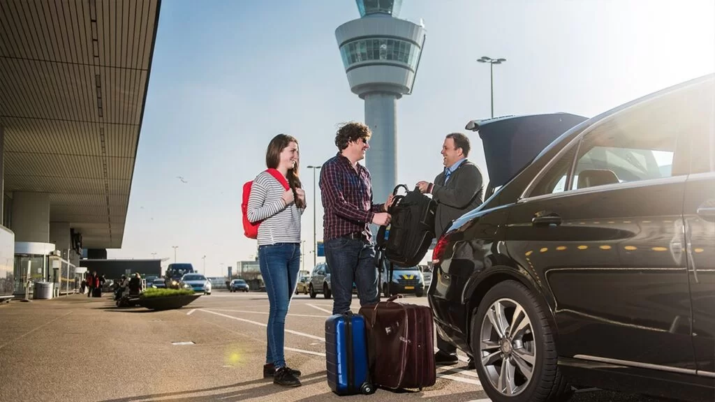A couple of tourist entering a car with a private driver