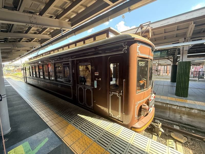 Traditional Japanese sightseeing train waiting at a station