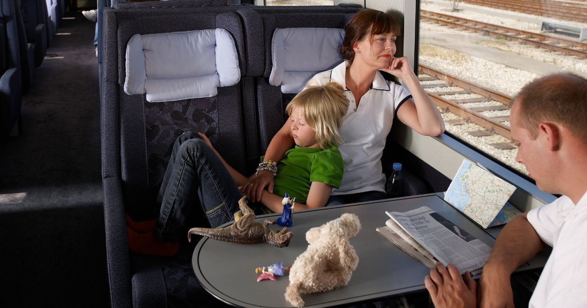 Family traveling together inside a train compartment