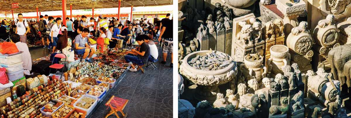 Open-air jade and antique stalls next to carved stone sculptures in a Chinese market
