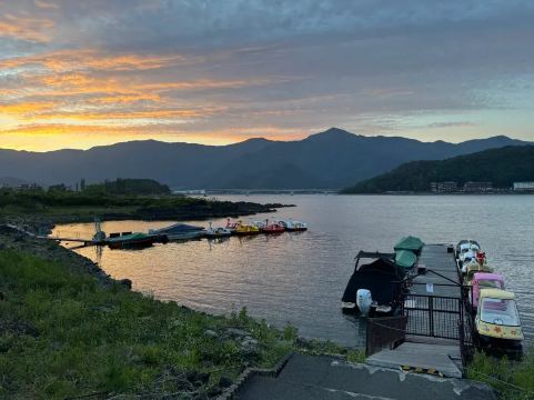 Lake Kawaguchi waterfront at sunset with colorful pedal boats
