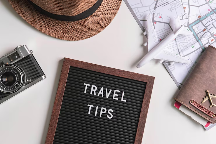 An image of a travelers items with a blackboard that says travel tips