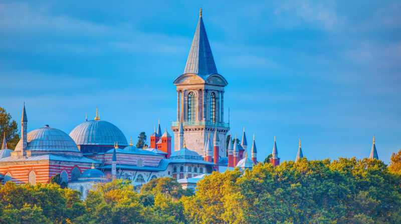 A view of Topkapi Palace in Istanbul, highlighting the Tower of Justice amidst the domes and gardens