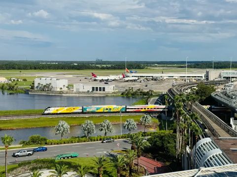 Orlando International Airport with aircraft, runways, and airport rail tracks
