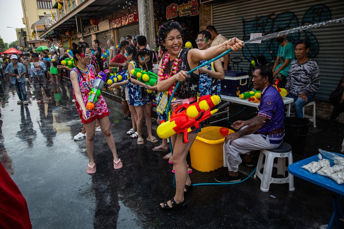 Tourist and locals enjoying Songkran, engaging in a water battle