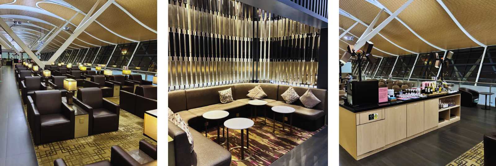 Una moderna lounge aeroportuale con comode poltrone, tavolini e un'area ristoro.