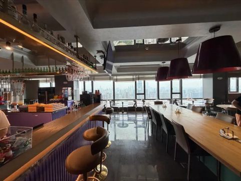 Restaurant dining area with a city skyline view