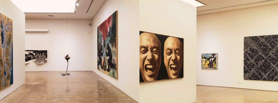 Interior of a contemporary art gallery in Hong Kong, featuring modern paintings and spacious, white-walled rooms.