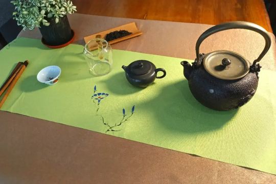 Traditional cast-iron kettle heating water for a Chinese tea ceremony