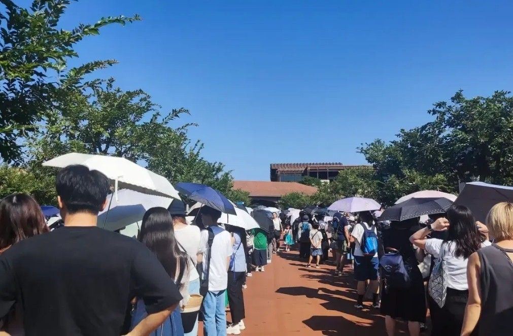 Visitors queuing outside Tokyo Disneyland before park opening