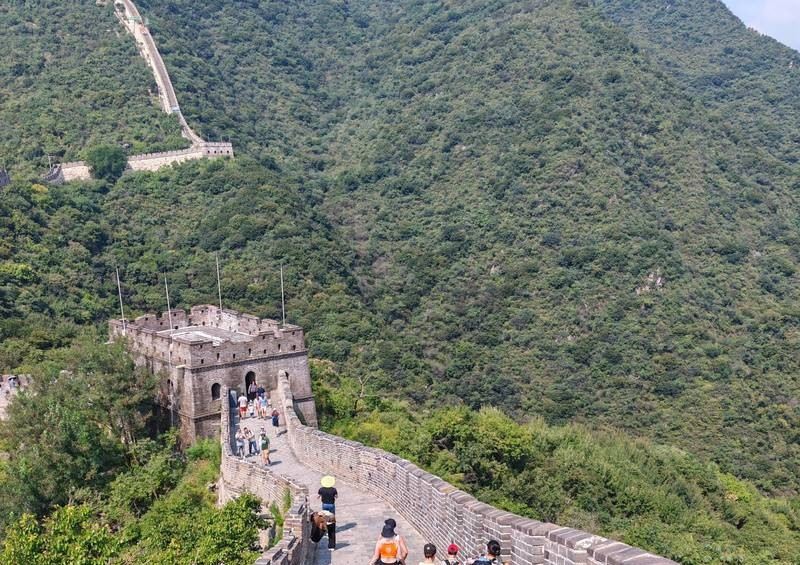 Great Wall watchtower and walkway winding through green mountains