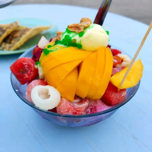 Delicious dessert with different assorments of tropical fruit and ice