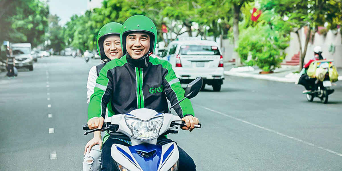A lady riding on a motorcycle taxi