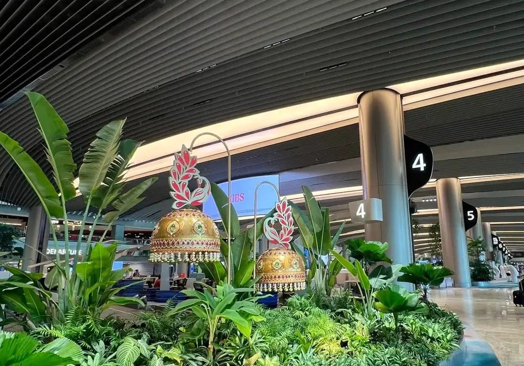 Decorative golden ornaments and tropical plants inside Changi Airport