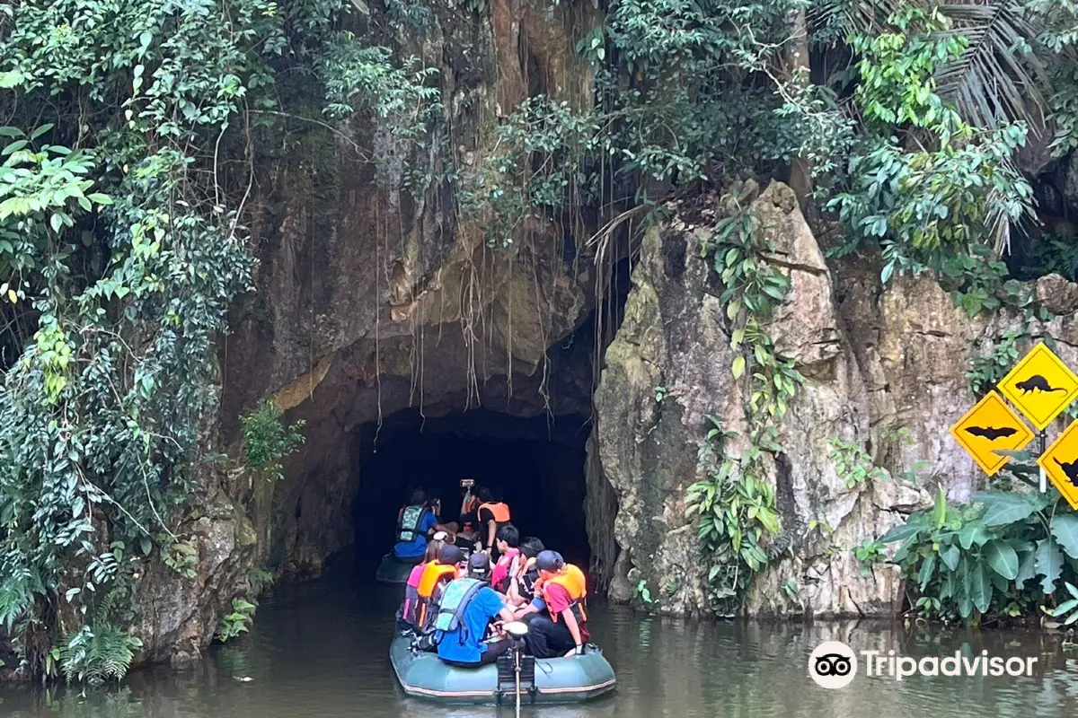 A group of adventurous tourist kayaking into a cave