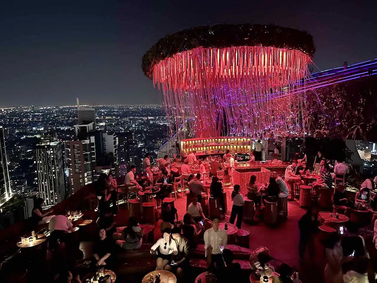 The feel good vibes of sky bars, having drinks while overlooking the view of the city at night