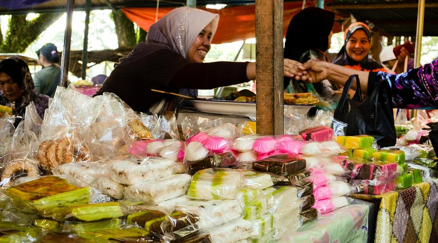 A seller selling kueh at the Kota Belud market