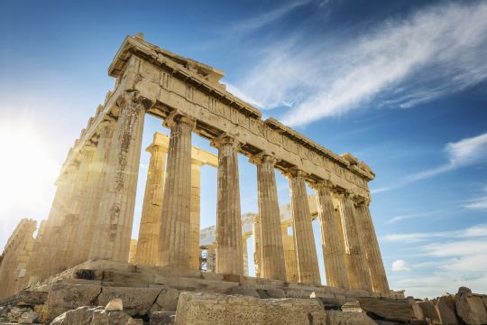 The columns of the Parthenon on the Acropolis, against a blue sky